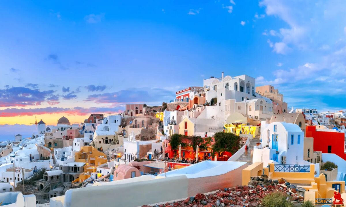 Colorful whitewashed buildings of Santorini at sunset