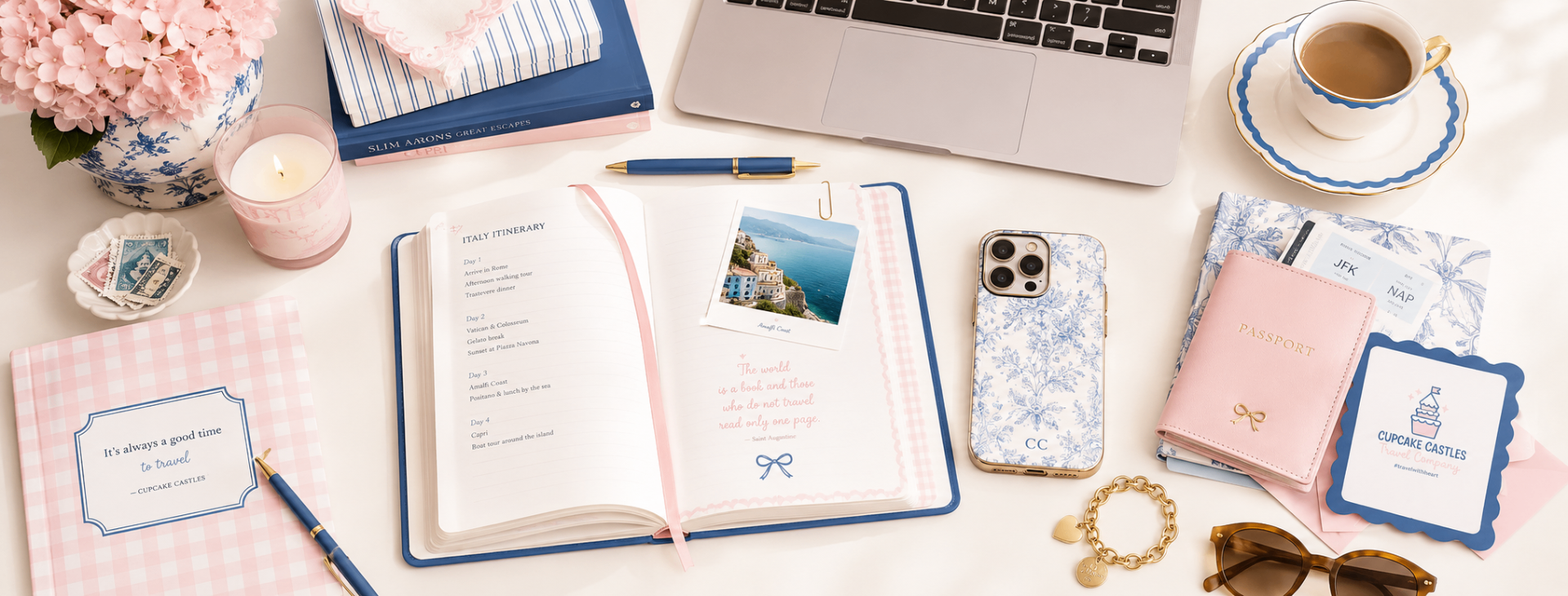 Cupcake Castles Travel Company branded flat lay with Italy itinerary, passport, laptop, coffee, and travel accessories